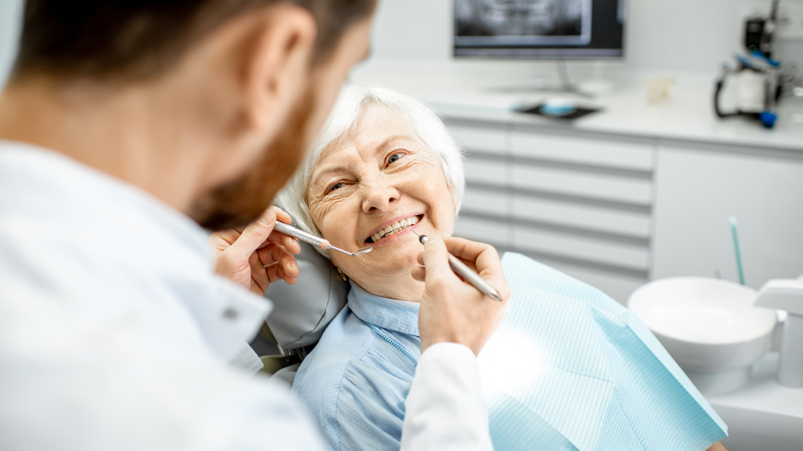 old woman at dentist smiling