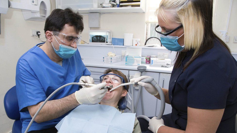 dentist-and-nurse-carrying-out-dental-treatment-on-patient