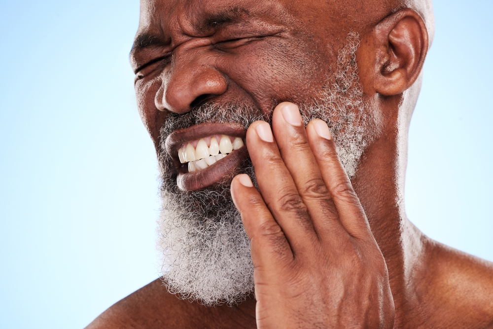 Man suffering from nerve pain after wisdom tooth extraction