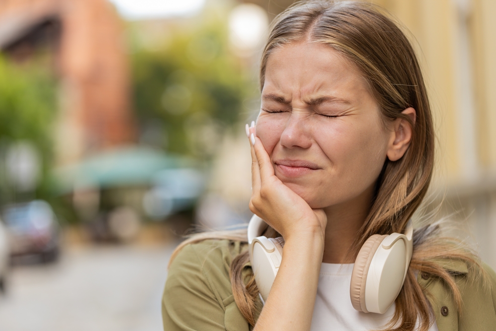 woman suffering with tooth nerve damage following dental negligence