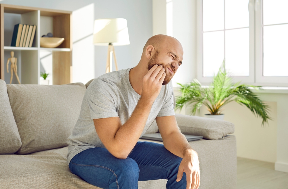 man suffering from dental nerve pain