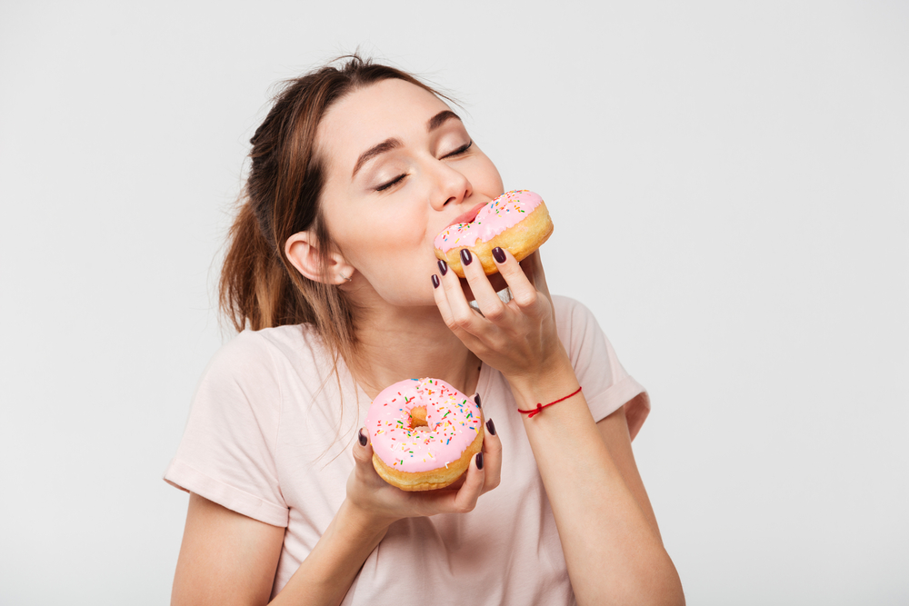 woman addicted to sugar eating donuts