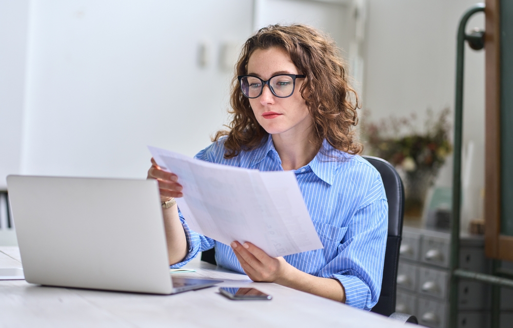 woman reading report on dental malpractice statistics
