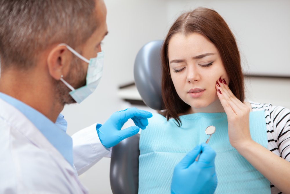 Young,Woman,Having,Toothache,,Sitting,In,A,Dental,Chair,
